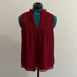 Red sleeveless blouse with gathered neck detail